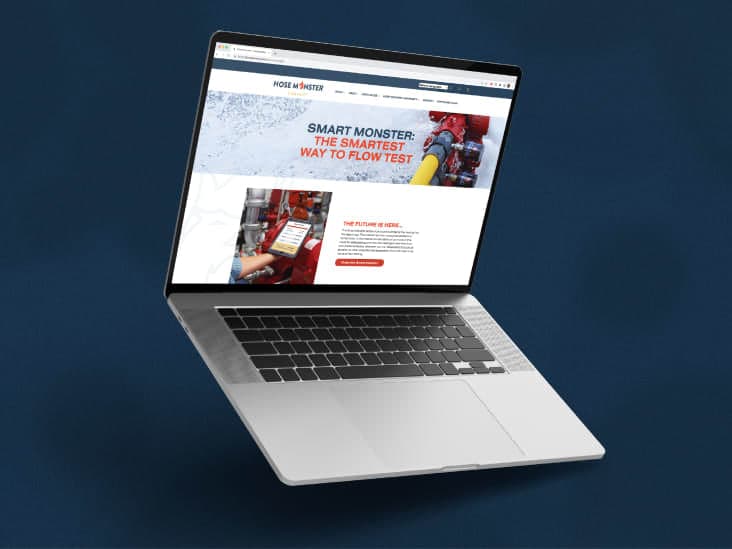 A laptop displaying the Hose Monster website focused on the Smart Monster app.